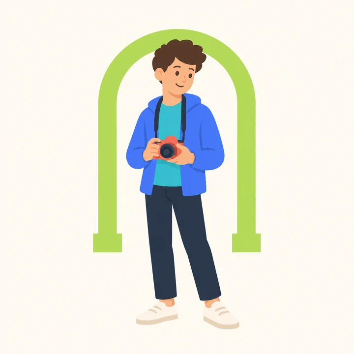 A fourteen-year-old holding a camera beside a simple architectural arch